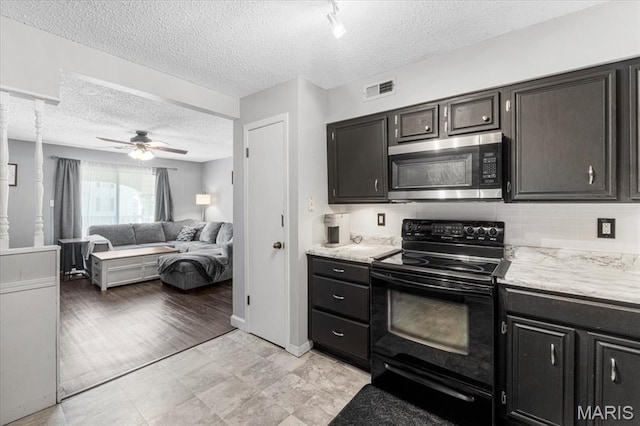 kitchen featuring stainless steel microwave, black electric range, a textured ceiling, a ceiling fan, and open floor plan