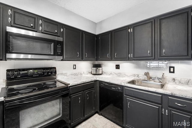 kitchen with black appliances, a sink, dark cabinets, tasteful backsplash, and a textured ceiling