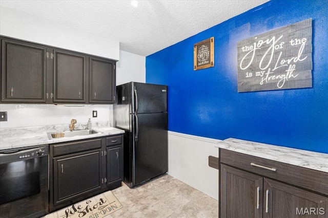 kitchen featuring black appliances, a sink, light countertops, and a textured ceiling