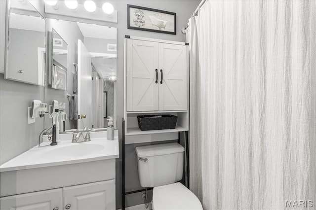 bathroom with toilet and vanity