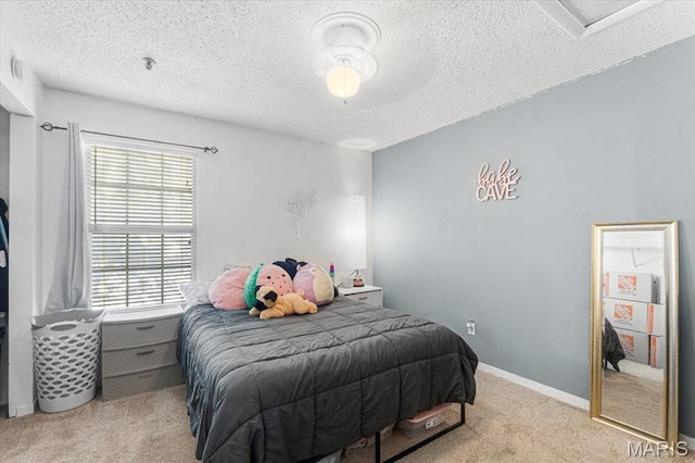 bedroom featuring light colored carpet and a textured ceiling