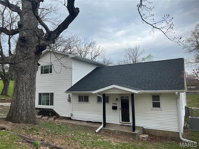 1512 36th St, Hannibal, MO 63401 - view of front facade featuring a shingled roof and cooling unit