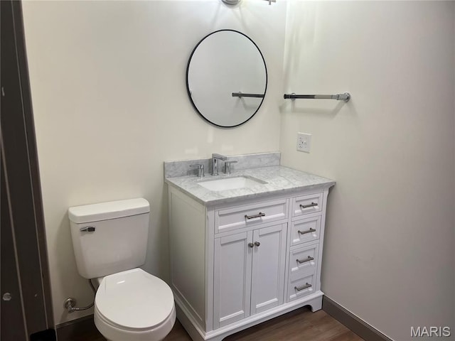 1512 36th St, Hannibal, MO 63401 - bathroom featuring vanity, toilet, and wood finished floors