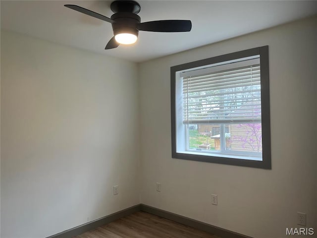1512 36th St, Hannibal, MO 63401 - empty room featuring wood finished floors, baseboards, and a ceiling fan
