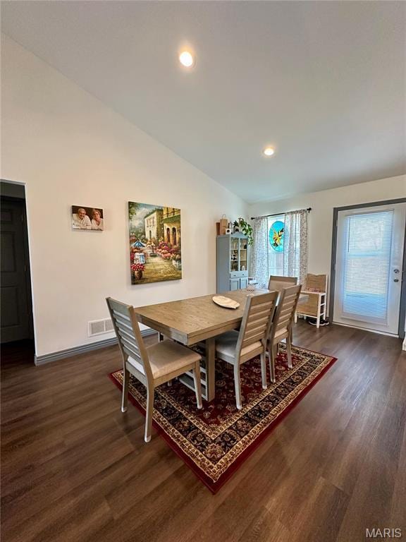 dining area with dark wood-style flooring, lofted ceiling, baseboards, and recessed lighting