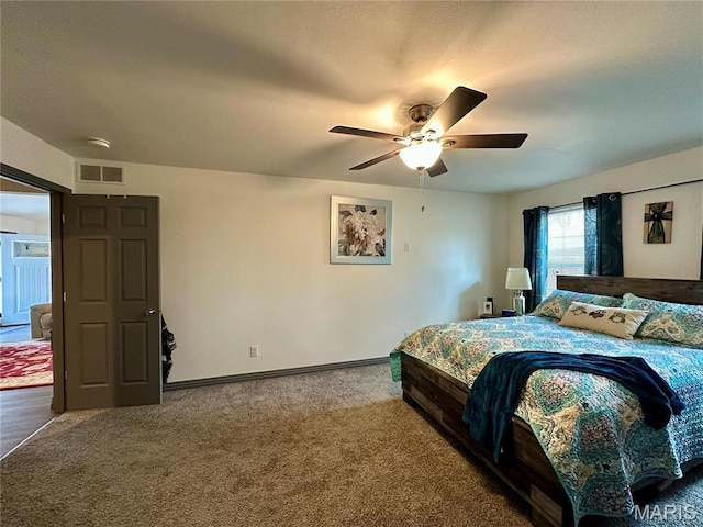 carpeted bedroom featuring baseboards and ceiling fan
