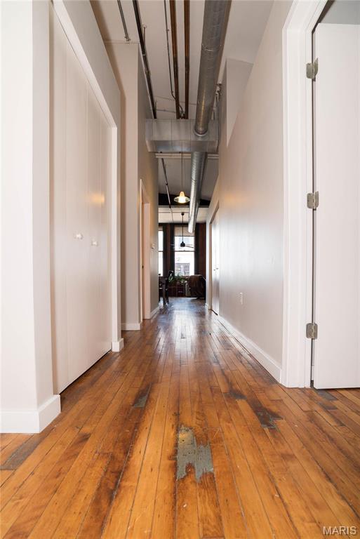 1520 Washington Ave Unit 604, Saint Louis, MO 63103 - hallway featuring hardwood / wood-style floors and baseboards