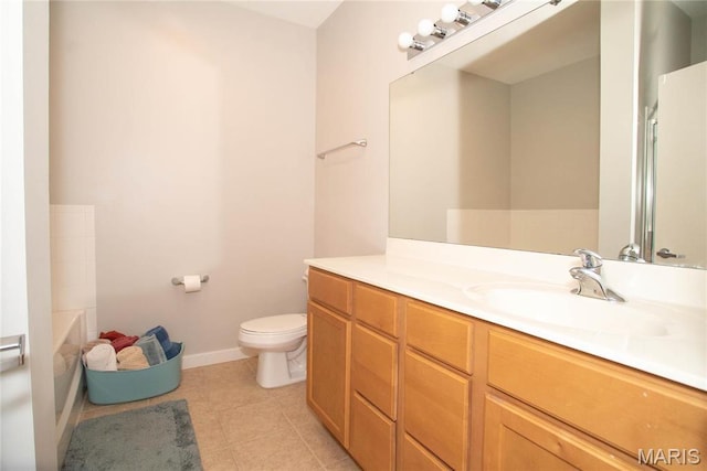 1520 Washington Ave Unit 604, Saint Louis, MO 63103 - bathroom featuring toilet, vanity, tile patterned flooring, baseboards, and a bath