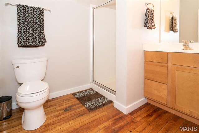 1520 Washington Ave Unit 604, Saint Louis, MO 63103 - full bath featuring a shower stall, hardwood / wood-style floors, toilet, and baseboards