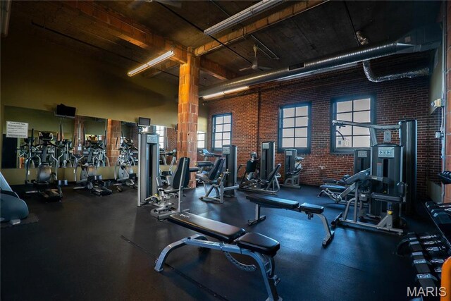 1520 Washington Ave Unit 604, Saint Louis, MO 63103 - exercise room featuring brick wall and a towering ceiling