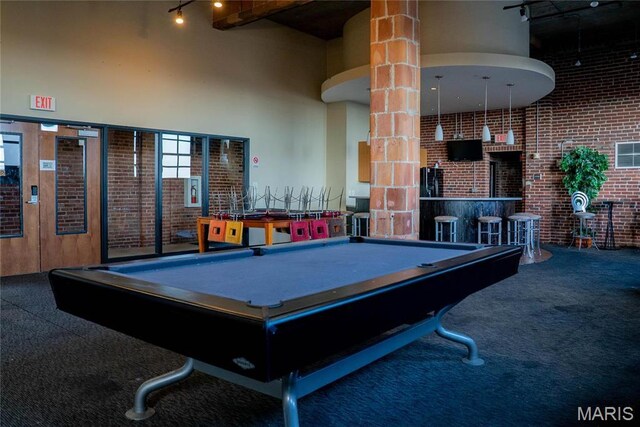 1520 Washington Ave Unit 604, Saint Louis, MO 63103 - rec room featuring brick wall, carpet flooring, billiards table, track lighting, and a towering ceiling