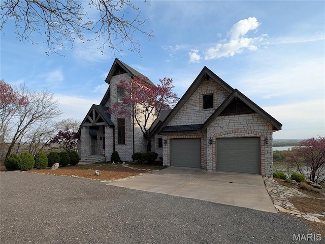 1 River Ridge Rd, Grafton, IL 62037 - view of front of property featuring driveway, a garage, and stone siding