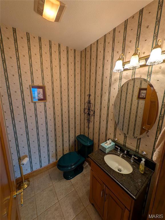 1 River Ridge Rd, Grafton, IL 62037 - bathroom featuring vanity, toilet, and tile patterned flooring