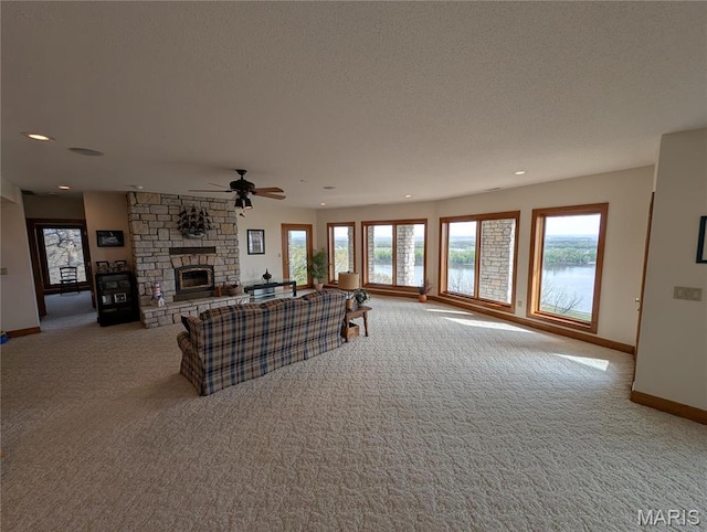 1 River Ridge Rd, Grafton, IL 62037 - carpeted living room with a fireplace, baseboards, ceiling fan, recessed lighting, and a water view