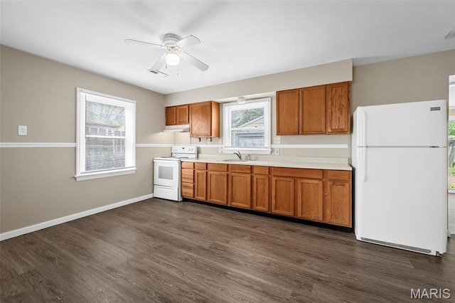 11225 Saint Shawn Ln, Saint Ann, MO 63074 - kitchen with white appliances, a sink, brown cabinetry, and light countertops