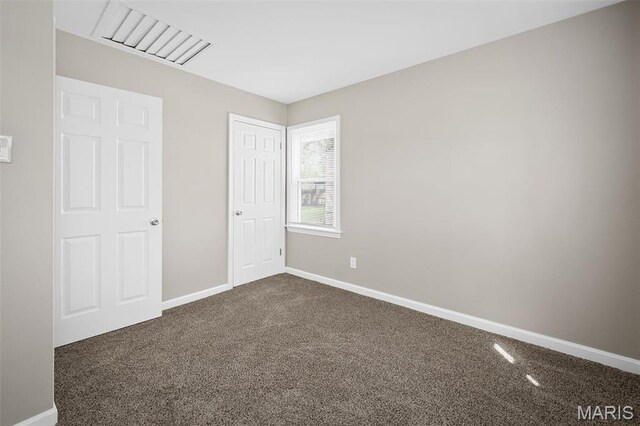 11225 Saint Shawn Ln, Saint Ann, MO 63074 - unfurnished bedroom with dark carpet and baseboards