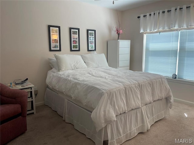 carpeted bedroom featuring baseboards