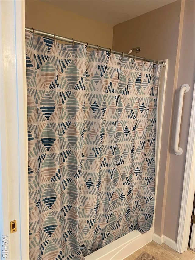bathroom with a shower with curtain and baseboards