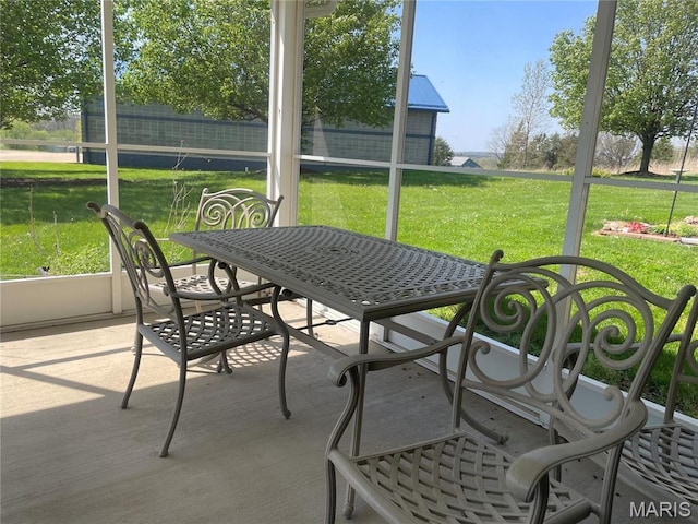 sunroom with outdoor dining area