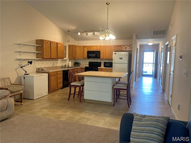 kitchen featuring black appliances, open shelves, open floor plan, a breakfast bar, and a kitchen island