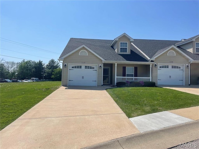 view of front of property featuring covered porch, a front lawn, driveway, a garage, and roof with shingles