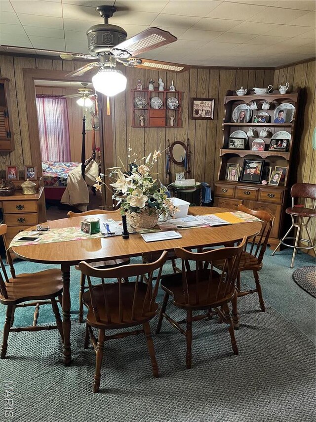 316 Bellvue St, Steele, MO 63877 - carpeted dining room with a ceiling fan and wooden walls