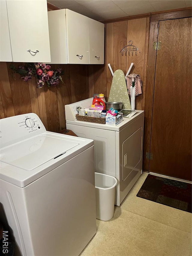316 Bellvue St, Steele, MO 63877 - laundry area with cabinet space, independent washer and dryer, and wooden walls