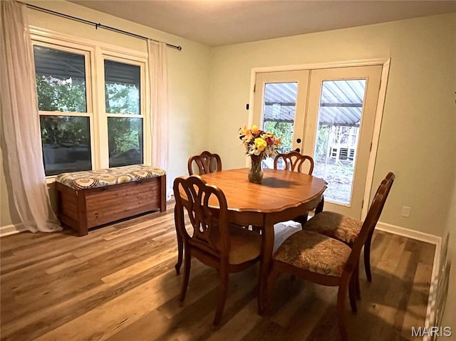 1531 Prather Ave, Saint Louis, MO 63139 - dining room featuring french doors, light wood-type flooring, and baseboards
