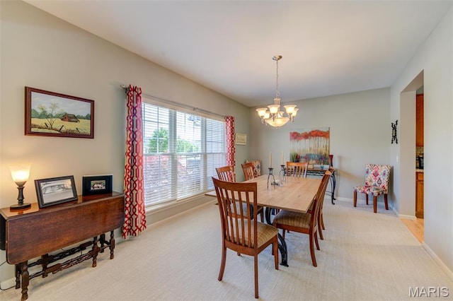 1024 Brook Mont Dr, Ofallon, MO 63366 - dining area with a chandelier, light colored carpet, and baseboards