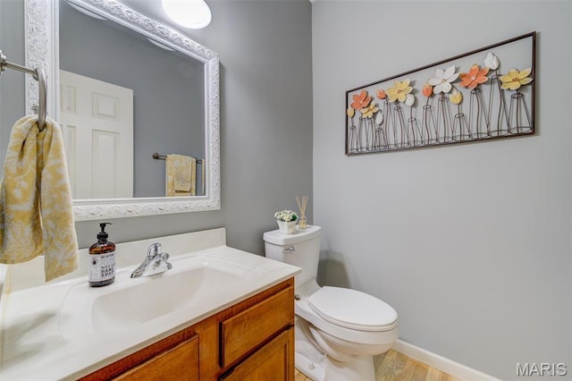 1024 Brook Mont Dr, Ofallon, MO 63366 - half bathroom featuring toilet, vanity, and baseboards