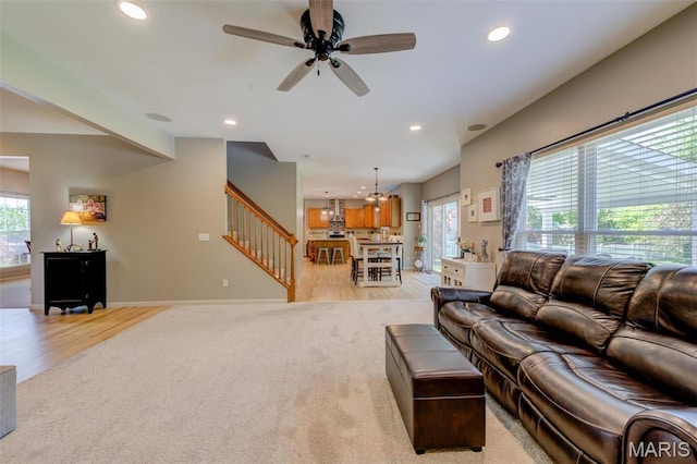 1024 Brook Mont Dr, Ofallon, MO 63366 - living area featuring light colored carpet, stairs, recessed lighting, ceiling fan, and light wood-style flooring