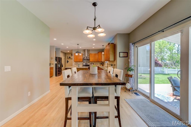 1024 Brook Mont Dr, Ofallon, MO 63366 - dining room with light wood-style floors, a chandelier, baseboards, and recessed lighting