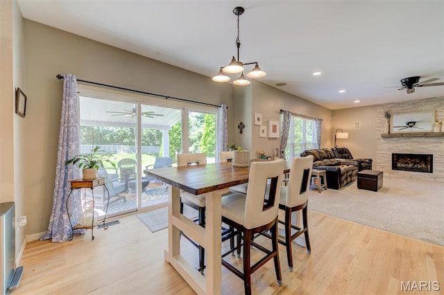 1024 Brook Mont Dr, Ofallon, MO 63366 - dining space featuring a ceiling fan, light wood-style floors, a fireplace, recessed lighting, and baseboards