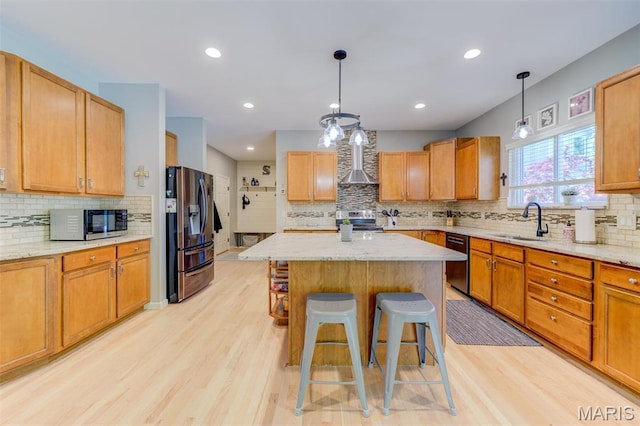 1024 Brook Mont Dr, Ofallon, MO 63366 - kitchen with appliances with stainless steel finishes, a sink, wall chimney exhaust hood, decorative backsplash, and light wood-style flooring