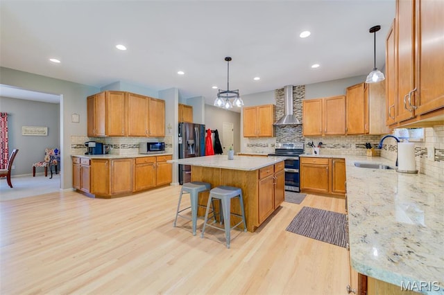 1024 Brook Mont Dr, Ofallon, MO 63366 - kitchen featuring appliances with stainless steel finishes, wall chimney exhaust hood, a sink, a center island, and decorative backsplash