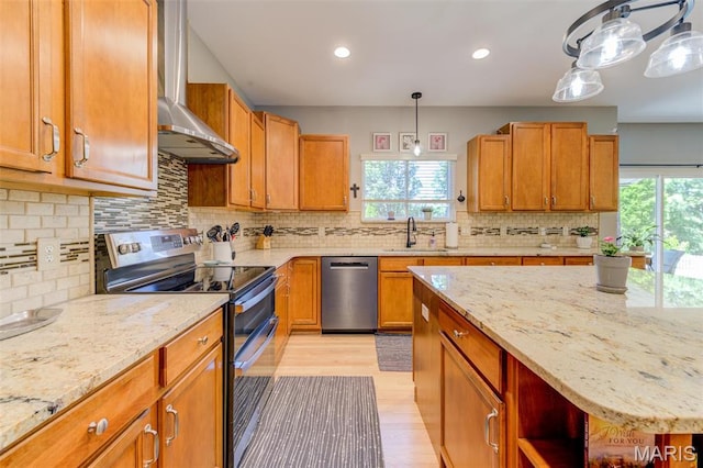 1024 Brook Mont Dr, Ofallon, MO 63366 - kitchen featuring stainless steel appliances, wall chimney range hood, a sink, healthy amount of natural light, and recessed lighting