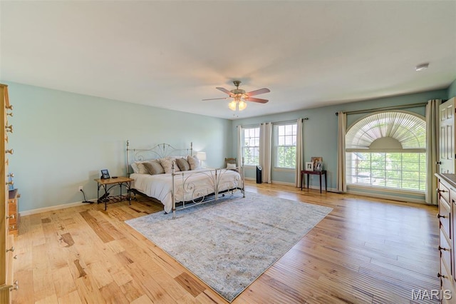 1024 Brook Mont Dr, Ofallon, MO 63366 - bedroom with light wood-style flooring, a ceiling fan, and baseboards