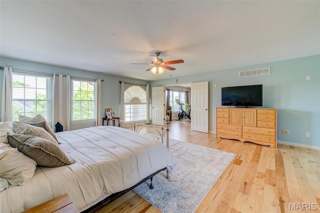 1024 Brook Mont Dr, Ofallon, MO 63366 - bedroom with light wood-type flooring, multiple windows, baseboards, and ceiling fan