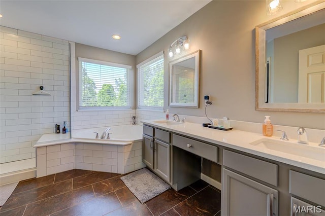 1024 Brook Mont Dr, Ofallon, MO 63366 - bathroom featuring a garden tub and double vanity