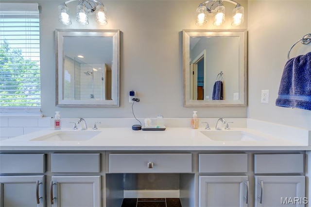 1024 Brook Mont Dr, Ofallon, MO 63366 - full bath with double vanity, a chandelier, and a tile shower