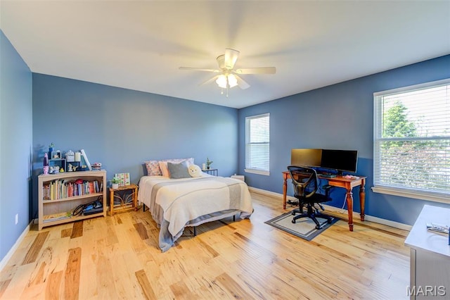 1024 Brook Mont Dr, Ofallon, MO 63366 - bedroom featuring light wood-type flooring, baseboards, a ceiling fan, and a desk