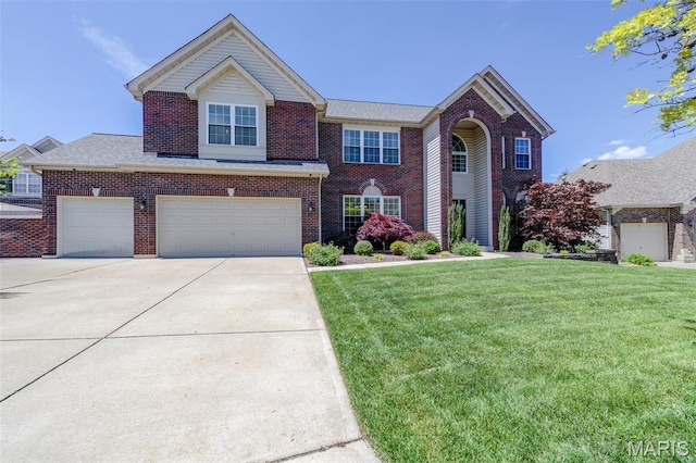 1024 Brook Mont Dr, Ofallon, MO 63366 - view of front of house with a front lawn, brick siding, concrete driveway, and a garage