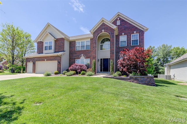 1024 Brook Mont Dr, Ofallon, MO 63366 - view of front of property featuring an attached garage, brick siding, cooling unit, concrete driveway, and a front yard