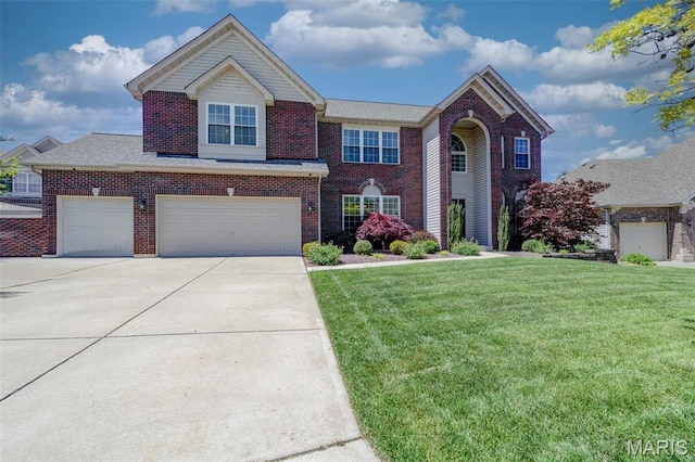 1024 Brook Mont Dr, Ofallon, MO 63366 - view of front of home featuring brick siding, a front yard, driveway, and an attached garage