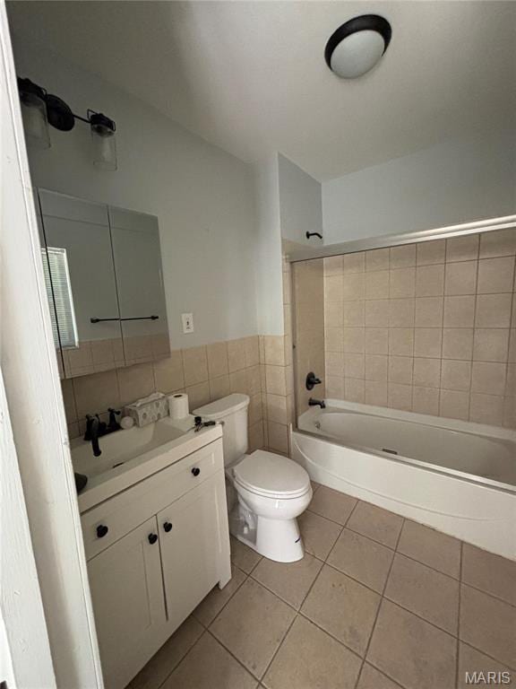5511 S 37th St, Saint Louis, MO 63116 - full bath with tile patterned flooring, tub / shower combination, toilet, tile walls, and vanity