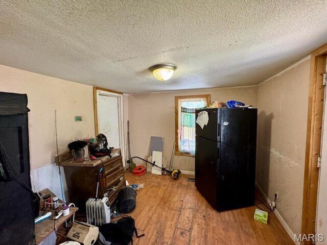 1018 Hayward St, Hannibal, MO 63401 - miscellaneous room featuring light wood-type flooring, a textured ceiling, and baseboards