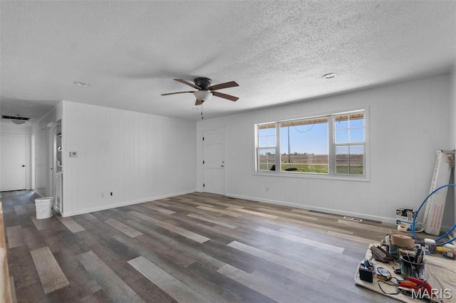 2112 County Highway 264, Gideon, MO 63848 - unfurnished living room with wood finished floors, a ceiling fan, a textured ceiling, and baseboards