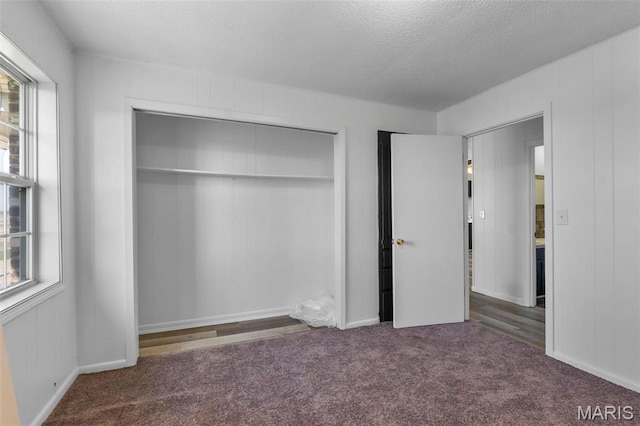 2112 County Highway 264, Gideon, MO 63848 - unfurnished bedroom featuring a closet, carpet floors, and a textured ceiling