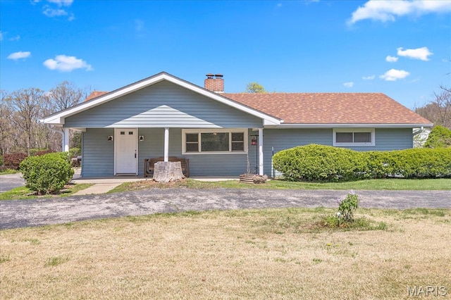 view of front of home featuring a front yard and a chimney