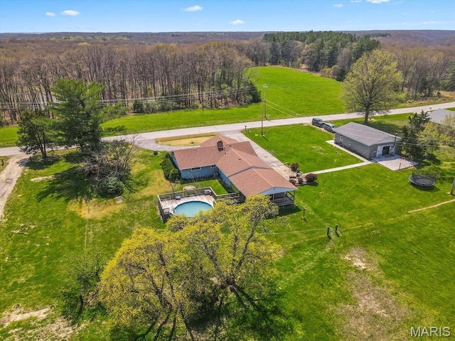 view from above of property with a forest and a pool
